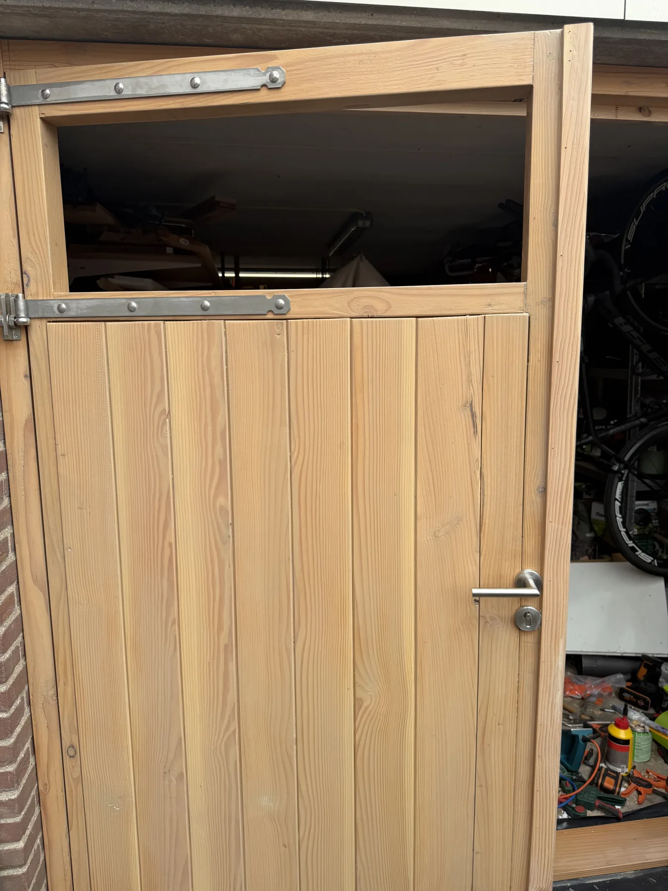 One leaf of the double garage door standing open, showing that it works