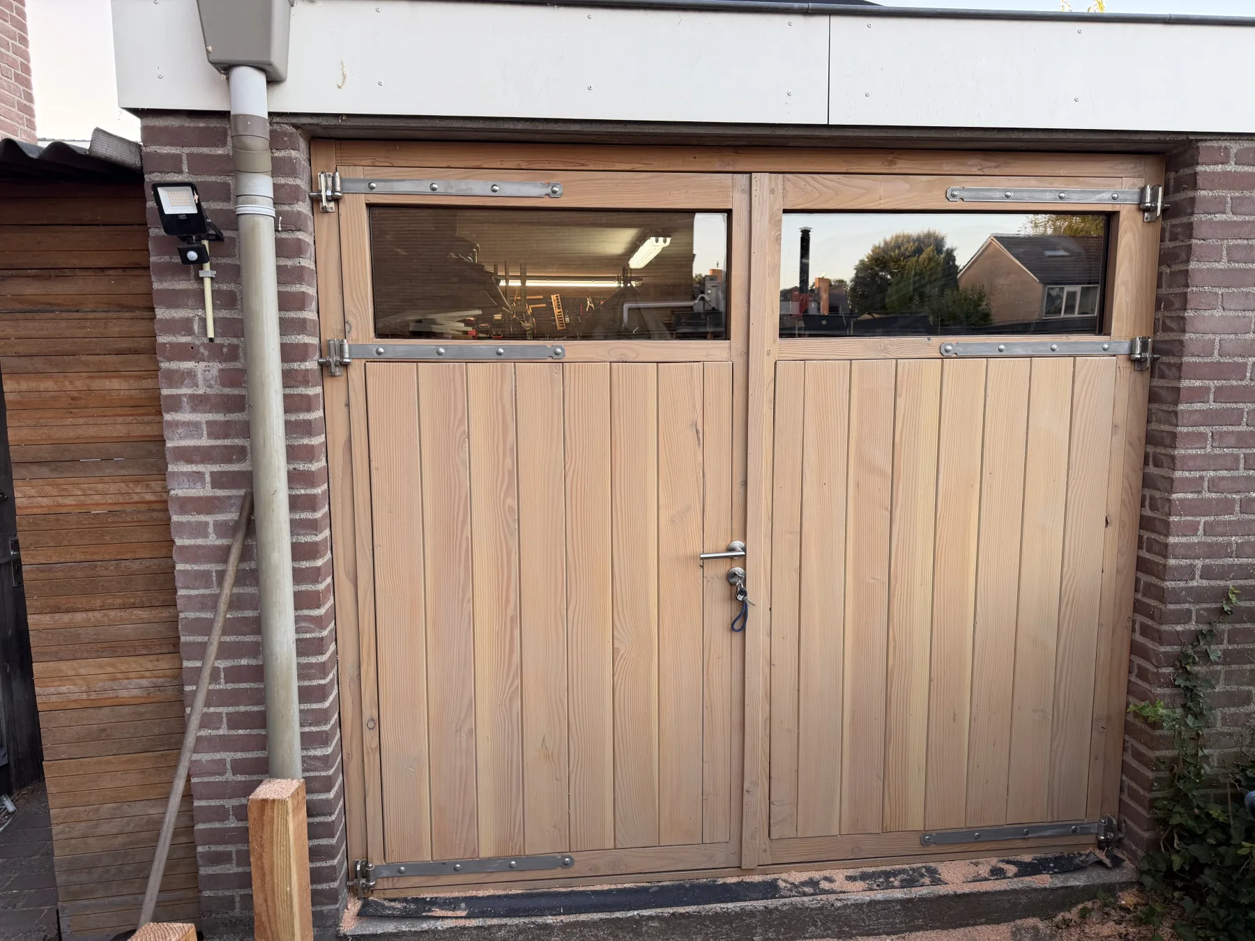 The finished garage doors with the glazing installed, in evening light