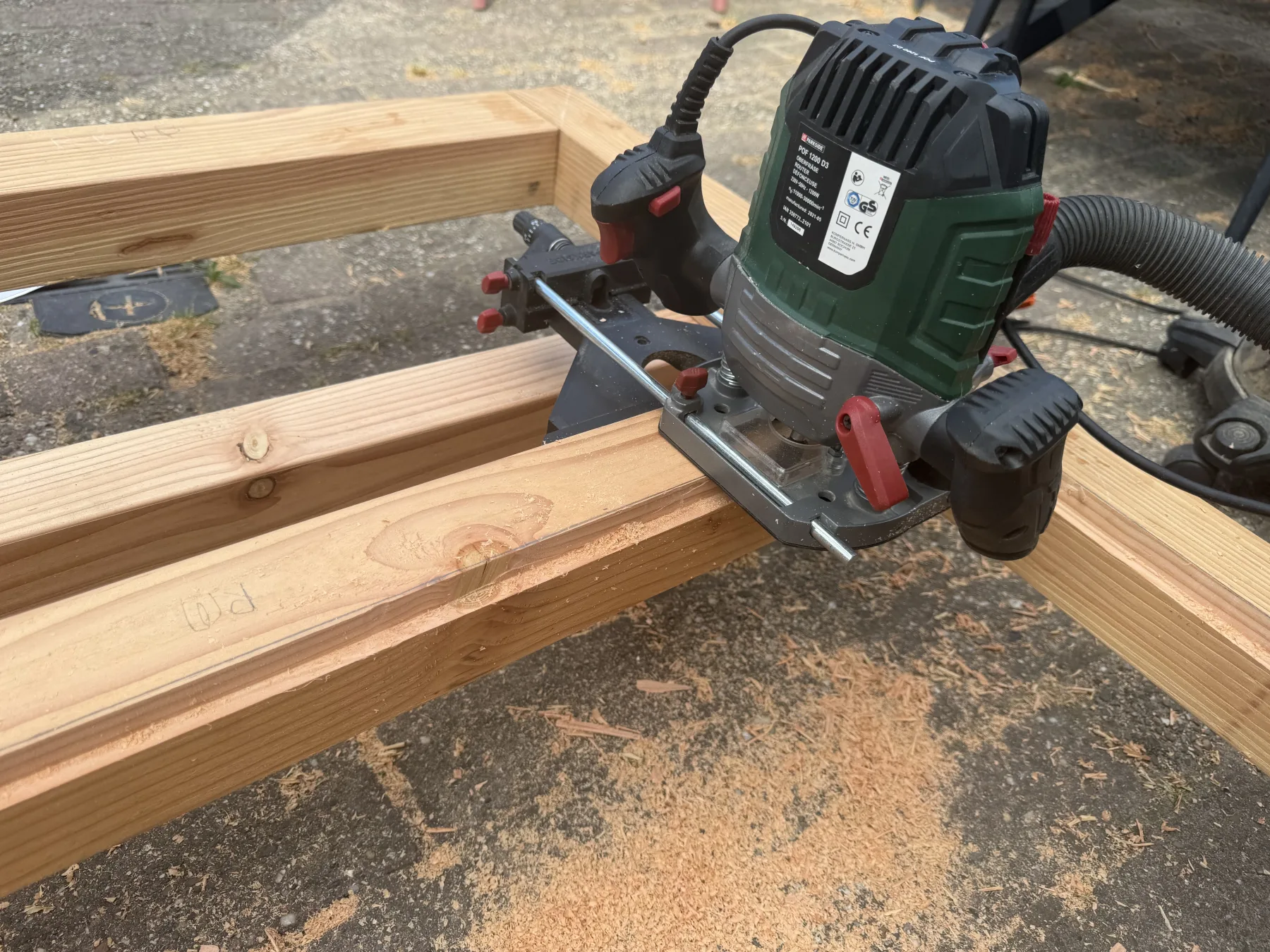 Router on the Douglas frame, with sawdust on the paving